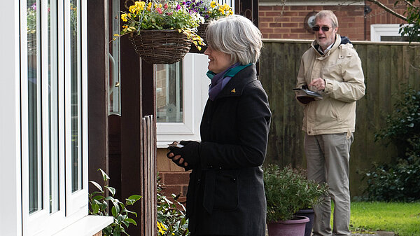 Claire Young speaking to a resident on the doorstep