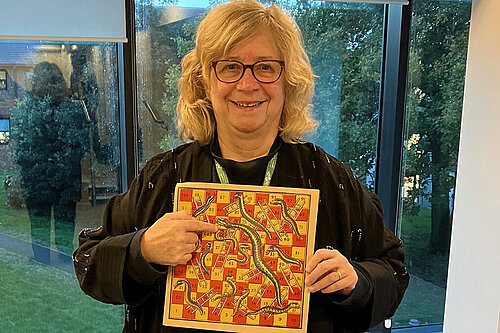 Councillor Chris Willmore with Snakes & Ladders game