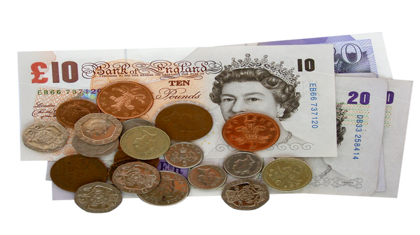 A pile of pound coins on top of notes.