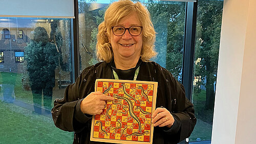 Councillor Chris Willmore with Snakes & Ladders game Councillor Chris Willmore with Snakes & Ladders game