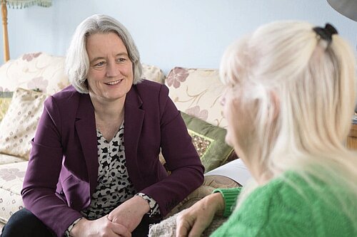 Claire discussing local healthcare with a resident