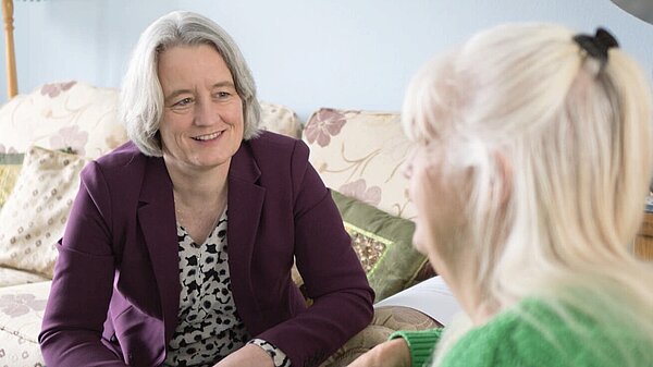 Claire discussing local healthcare with a resident