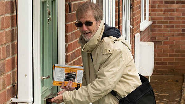 Lib dem volunteer delivering leaflets